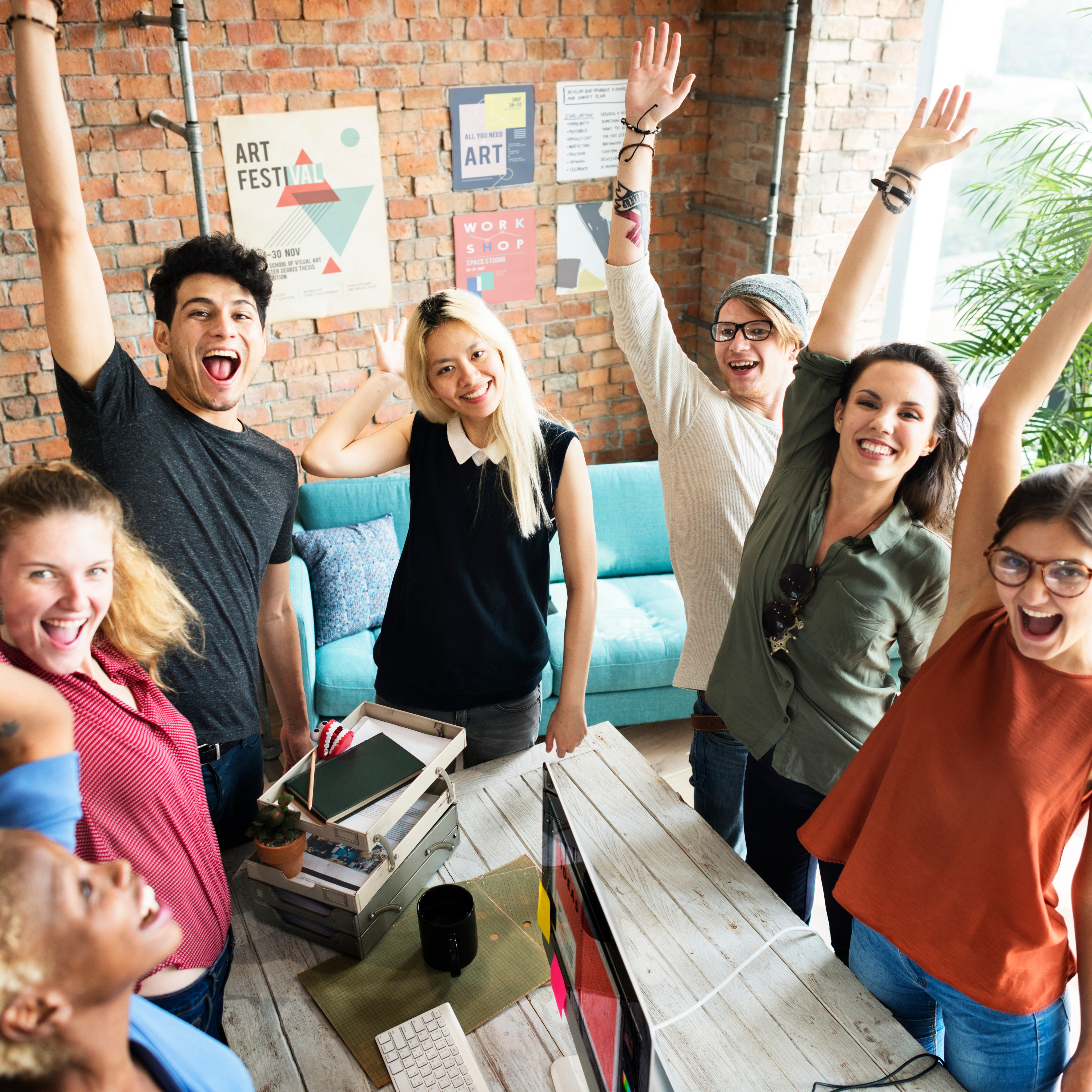 Team members cheering together at the office